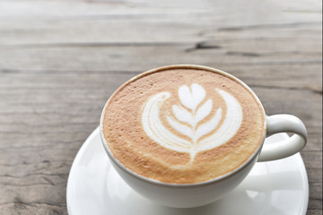 Coffee cup with latte art foam on wood table in coffee shop with copy space.Coffee is one of the most popular beverages.Improve Energy Levels and Burn Fat