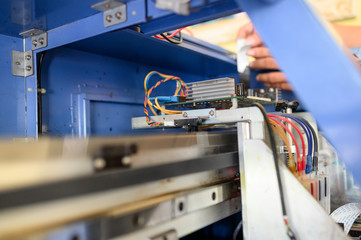 Technician repairing mainboard of colors dispensers of inkjet printer