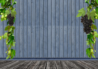 of wild grapes and hop leaves on a wooden wal with copy space