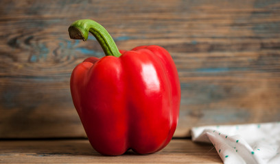 Sweet bulgarian red bell pepper on wooden background