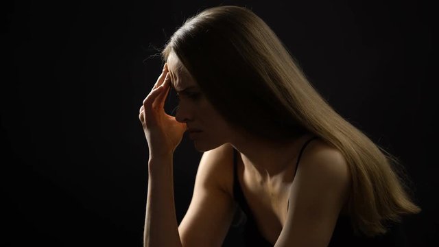 Lonely woman massaging head, suffering from migraine and stresses, problem