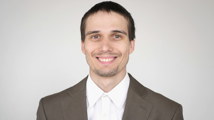 portrait of young smiling attractive successful businessman on a white background