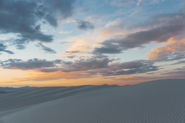 Fototapeta na wymiar colorful desert sunset over gypsum sand dunes at White Sand National Monument, New Mexico