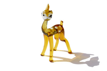 glass figurine fawn with a broken ear isolated on a white background with a shadow