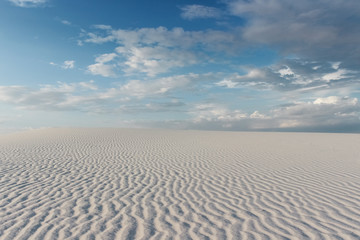 Fototapeta na wymiar desert landscape with sand ripples, blue sky and clouds at White Sand National Monument, New Mexico
