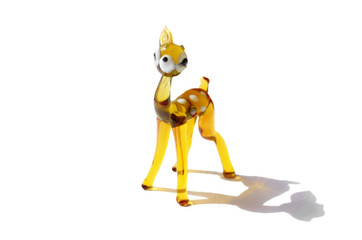 glass figurine fawn with a broken ear isolated on a white background with a shadow
