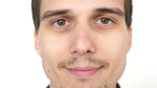 Face of young attractive successful man on a white background. Close up. 3840x2160. slow motion