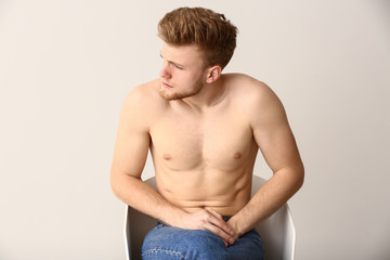 Man with urologic disease on white background