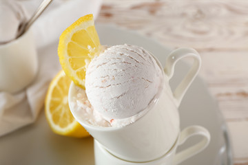 Cup with tasty ice cream on table, closeup