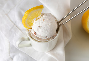 Cup with tasty ice cream on table, closeup