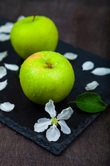 Green apples, flowers and leaves
