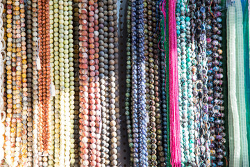 Multicolored handmade beads. Colorful background of the bead. Fashionable craft of women. Decoration of stones. Shop for creativity.