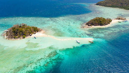 A small island for tourists with a sand bar.Tourists rest on a small island. Philippine Islands aerial view. Philippines, Palawan