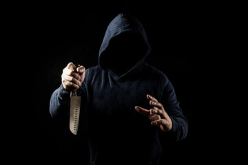 Bandit with knife on dark background