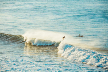 Naklejka premium Surfers and Waves at Bells Beach, Australia