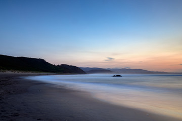 Fototapeta na wymiar Sunset on the “playón de bayas”, on the coast of Asturias, Spain
