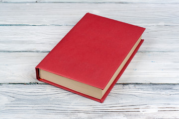 Open hardback book, on wooden table. natural background . Back to school. Copy space for text.