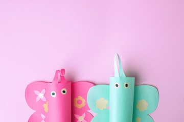 Minimal easter holiday spring summer time pink concept - couple of papaercraft handmade naive butterfly on pink candy color background, cute creative idea