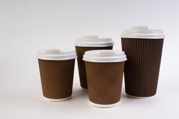 Many disposable paper cups of coffee, tea on white background with clipping path.