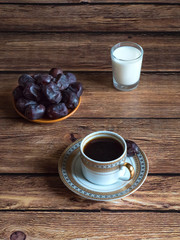 Coffee with dates and a glass of milk.