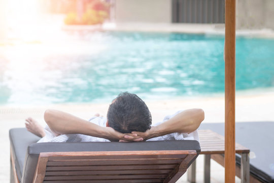 Easy relax business man lifestyle after work at hotel sitting hands behind head for happy businessman people. Simplify Your Life Week. International happiness day. Work-life balance concept. - Powered by Adobe