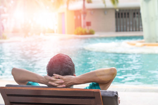 Easy relax business man lifestyle after work at hotel sitting hands behind head for happy businessman people. Simplify Your Life Week. International happiness day. Work-life balance concept. - Powered by Adobe