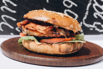 Fresh tasty chicken burger on wood table