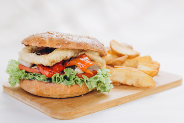 Big tasty burger on background on the wooden table