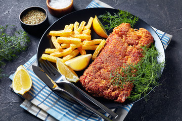 close-up of Breaded hake fillet on a plate