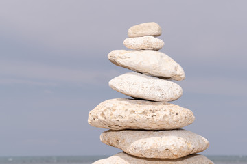 Fototapeta na wymiar Zen balance pebble white stones stack stability