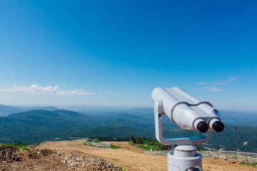 Coin operated electronic binoculars for tourists on a mountain landscape