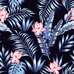 Blue tropical leaves pink flowers black background