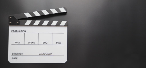 Fototapeta na wymiar White Clapperboard or clap board or movie slate use in video production ,film, cinema industry on black background.