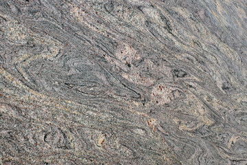 Natural stone granite of gentle pink color with gray stains