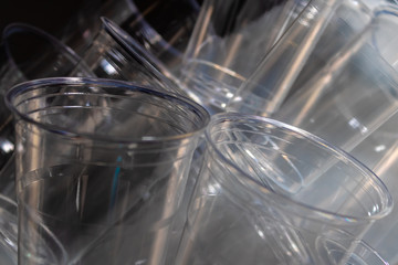 Two transparent plastic glasses closeup, non-compostable waste - Image