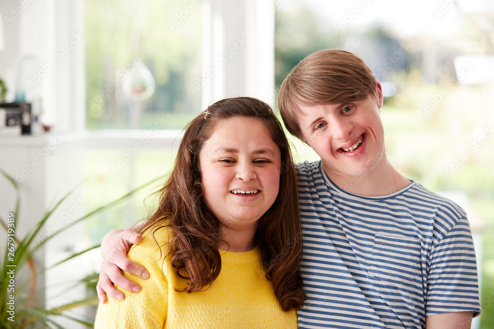 Wall mural Portrait Of Loving Young Downs Syndrome Couple At Home Together