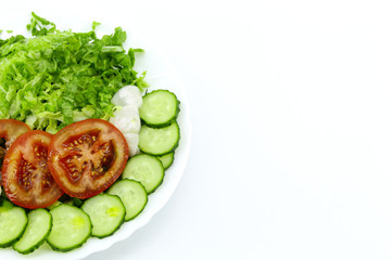 Sliced vegetables in a round white plate