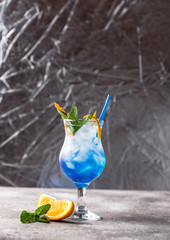 Blue lagoon cocktail  with ice and orange