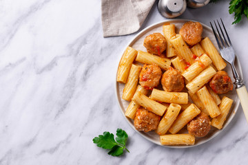 Pasta with meatballs in tomato sauce.