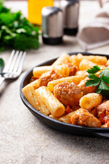 Pasta with meatballs in tomato sauce.