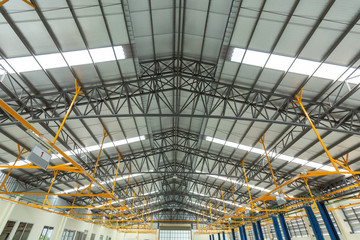 Steel roof truss in car repair center, Steel roof frame Under construction, The interior of a big industrial building or factory with steel constructions.
