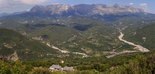 Fototapeta na wymiar The mountains and the river Kalarrytikos on a sunny summer day.