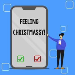 Handwriting text writing Feeling Christmassy. Conceptual photo Resembling or having feelings of Christmas festivity Man Presenting Huge Blank Screen Smartphone while Holding Another Mobile