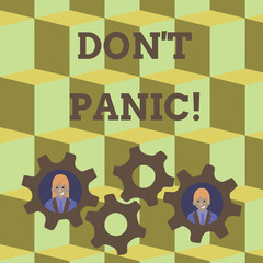Word writing text Don T Panic. Business photo showcasing suddenly feel so worried or frightened that you can not behave Two Business People Each Inside Colorful Cog Wheel Gears for Teamwork Event