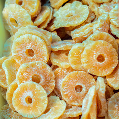 Very tasty and sweet dried pineapple slices on a fruit market in eastern Spain on a sunny day.