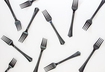 Black forks on a white background. Minimal concept. Abstract.