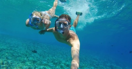POV of young attractive couple snorkeling together