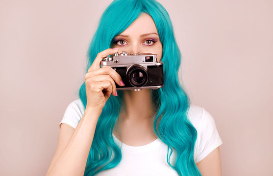 Young woman with retro camera studio shot