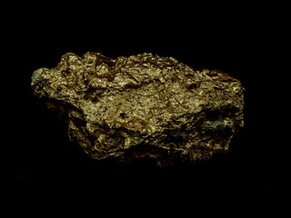 macro Gold ore in the boulder , precious stone on black  background