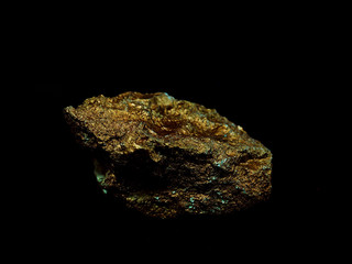 macro Gold ore in the boulder , precious stone on black  background